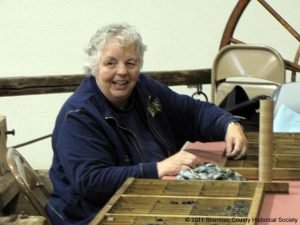 Sherry Kaseberg organizing Sherman County Journal artifacts.